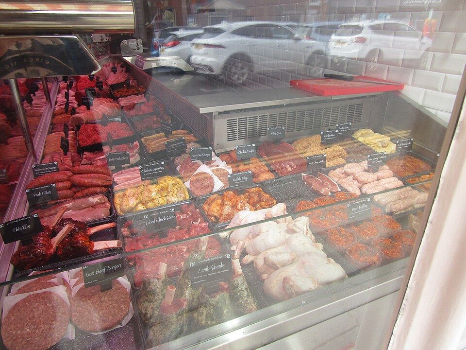 Cuts of meat on display at a butcher's counter