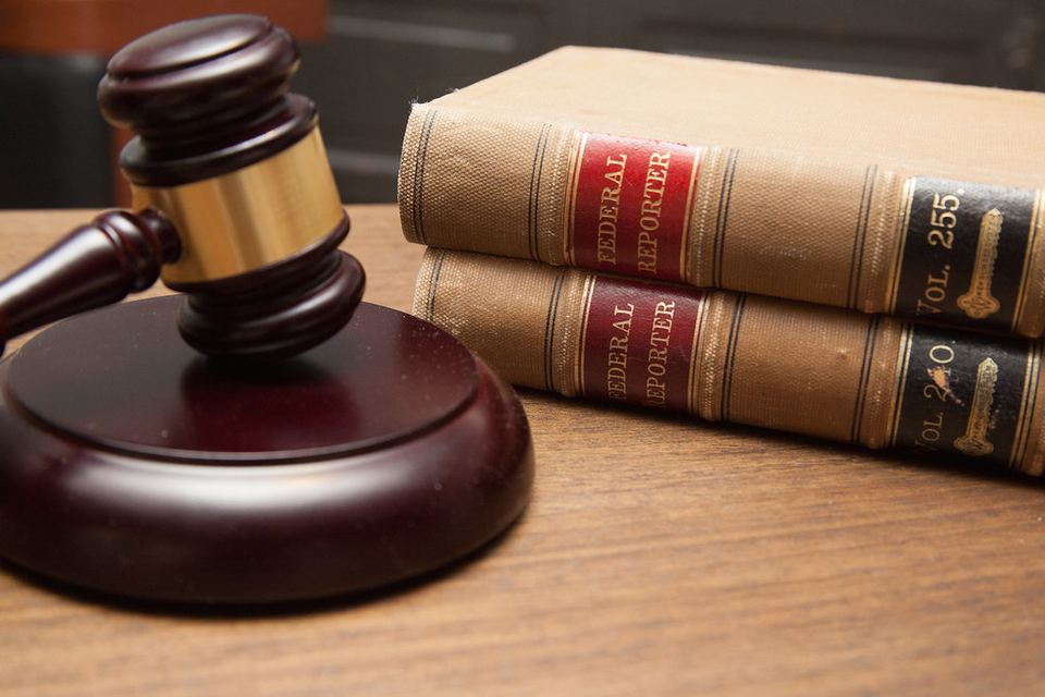 A judge's gavel resting on a wooden block