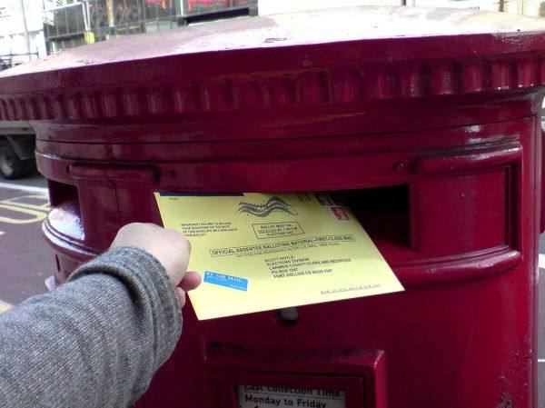 A ballot being dropped into a ballot box